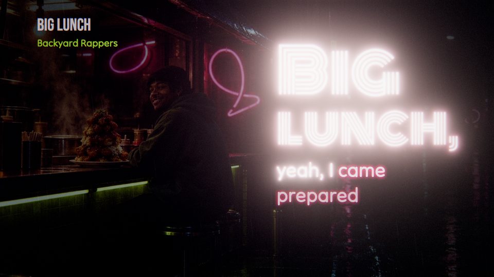 Lyrics glowing in pink neon over a dark bar at night